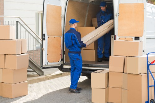 Local removal team preparing a Hackney home move with packed boxes